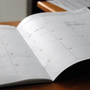Open monthly planner on a wooden desk