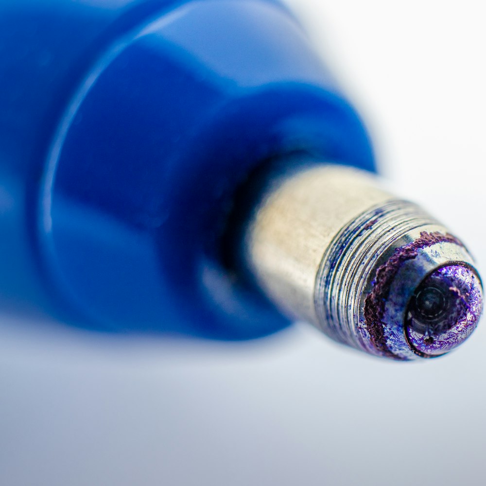 Close-up of a blue pen on a white background