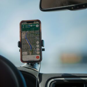 Smartphone showing a navigation route on a car dashboard