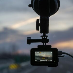 A small camera mounted on a car windscreen at sunset