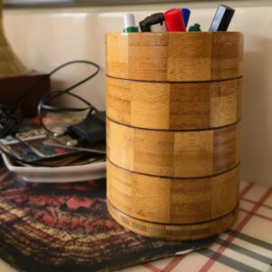 Pencils and pens in a wooden desk holder