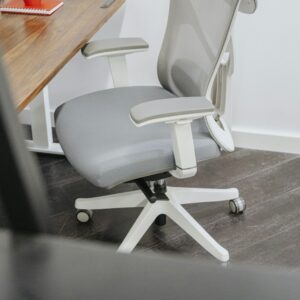 Grey office chair beside a wooden desk