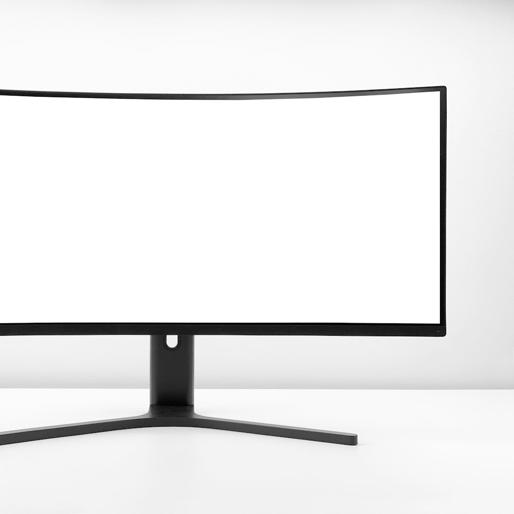 A white monitor with a black stand