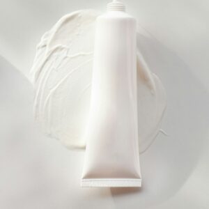 A tube of cream on a white plate