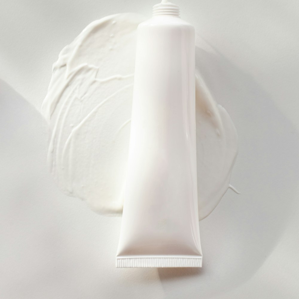 A tube of cream on a white plate