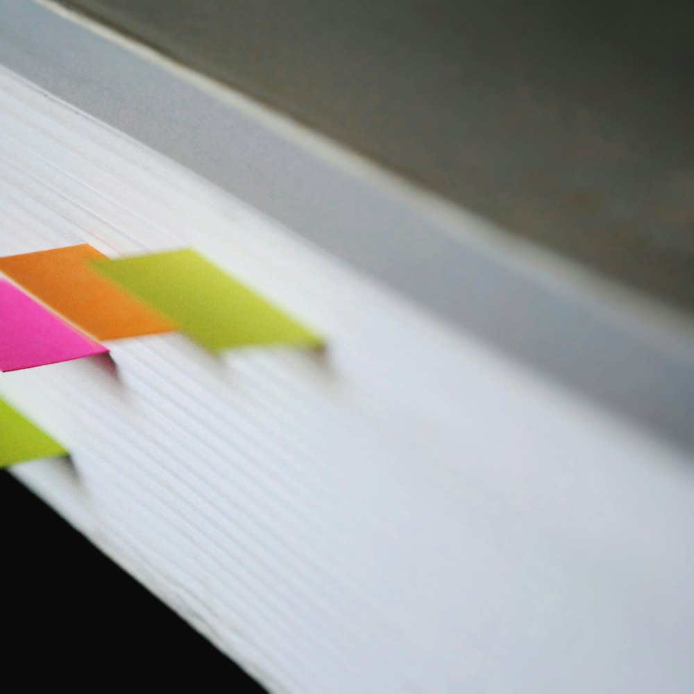 Green, pink and orange page markers in close-up