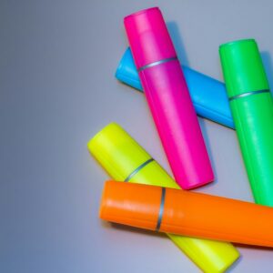 Several colourful highlighters scattered on a surface