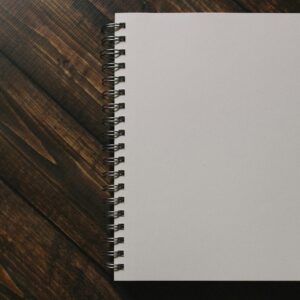 White spiral notebook on a wooden table