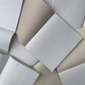 Open exercise books with squared paper and plain brown covers