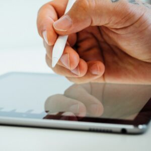 Hand holding a white stylus pen