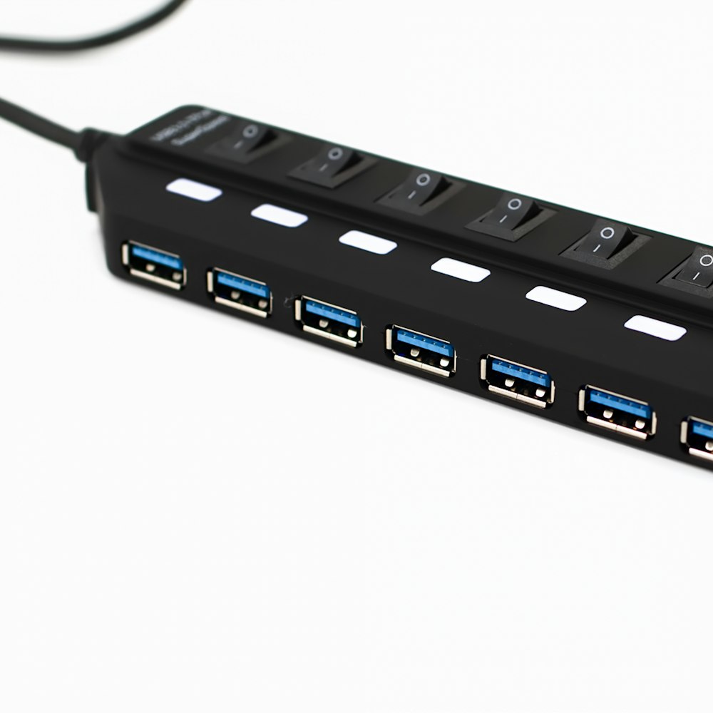 A black USB hub with seven ports and switches