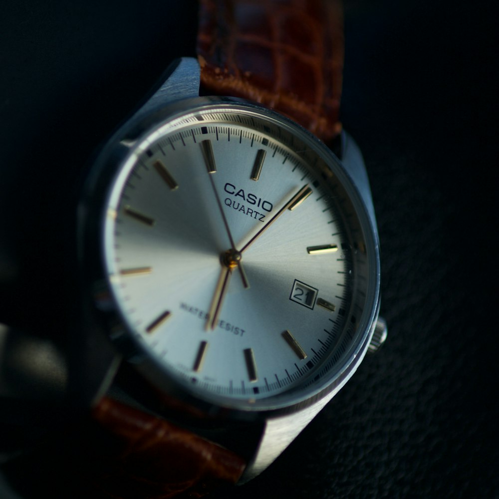 Silver and white analogue wristwatch
